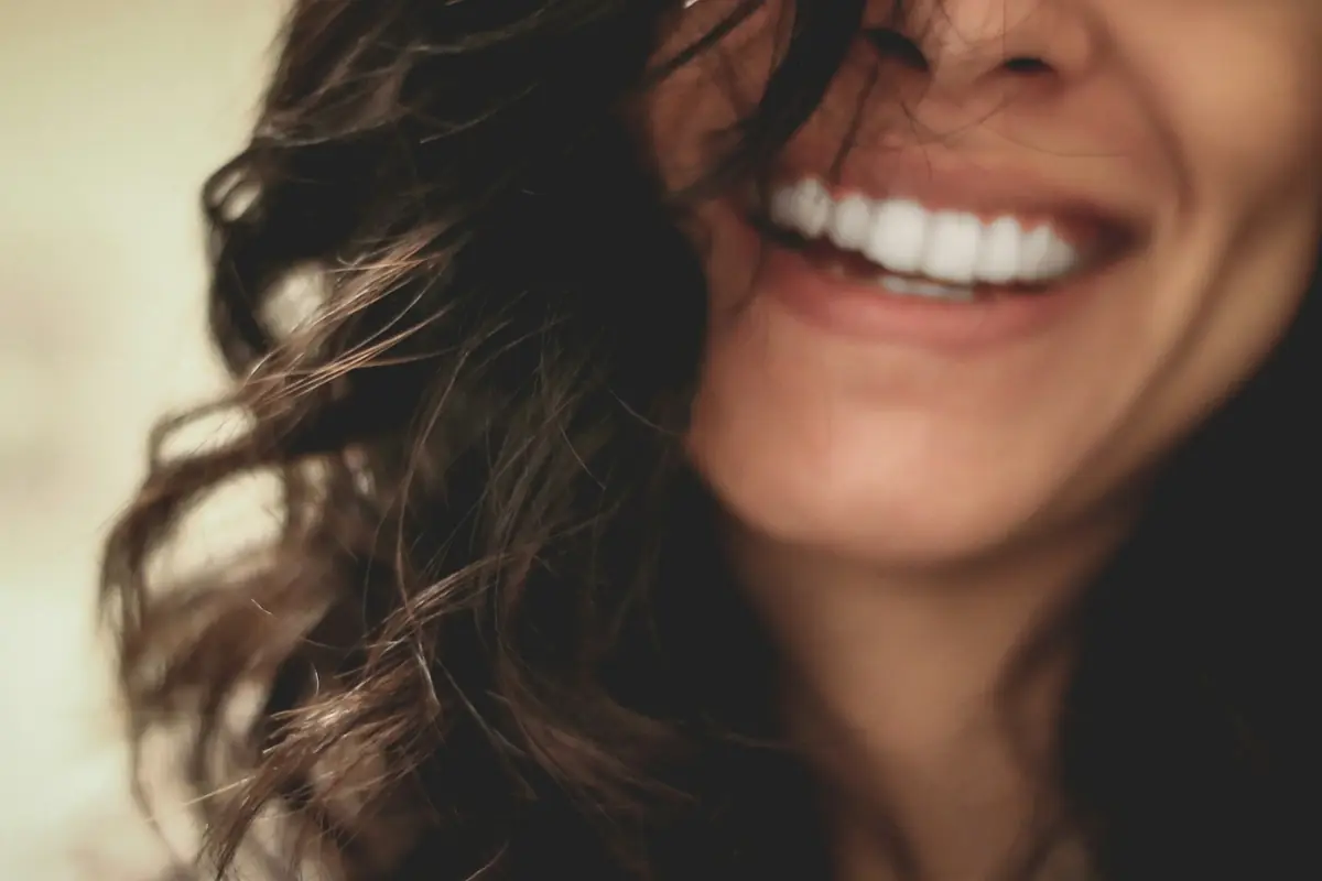 A woman laughing, close up on her smile